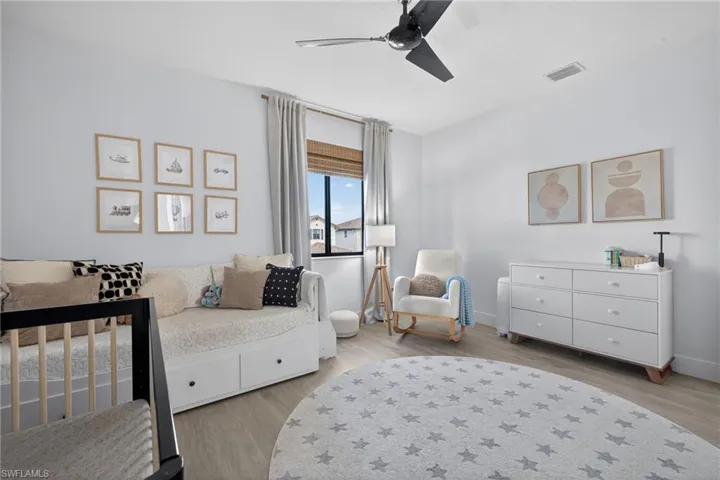 Bedroom featuring light wood-style flooring and a ceiling fan