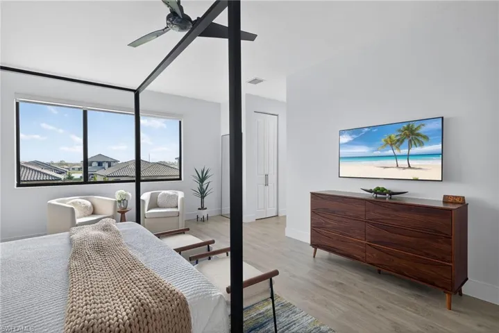 Bedroom with light wood-style flooring and a ceiling fan