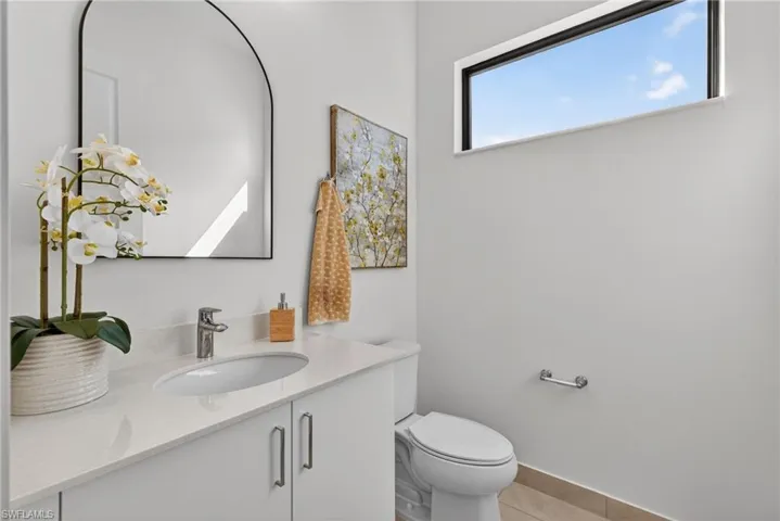 Bathroom with vanity and light tile patterned flooring