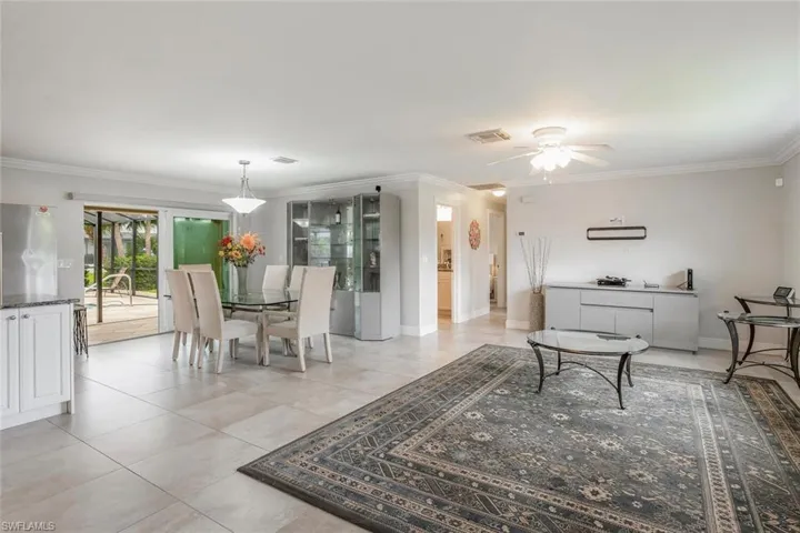 Open floor plan with kitchen, dining, living area opening to pool and lanai. Home is being sold turnkey.