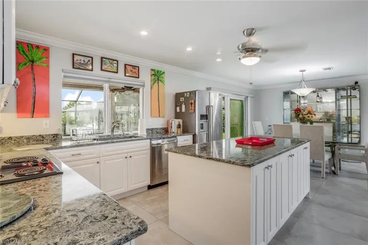 Professionally remodeled kitchen with granite, tile backsplash, stainless appliances, Jenn-Aire range, plus large Island with added storage, Upgraded tile flooring too.