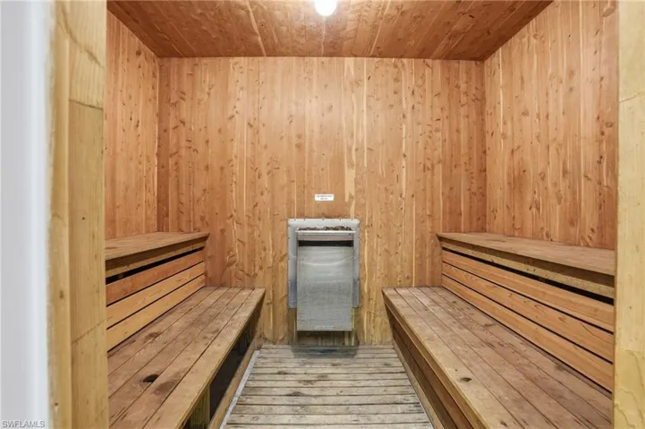 Sauna / steam room featuring wood ceiling and wooden walls