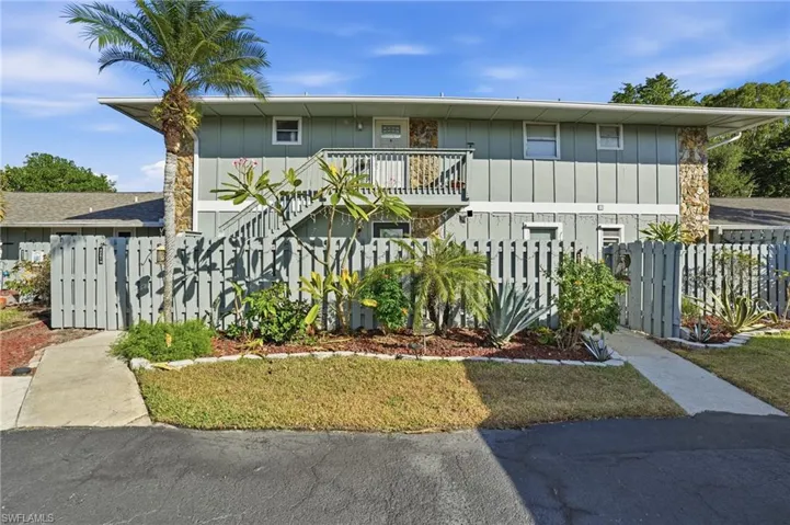 View of front of condo , stairway, and a balcony