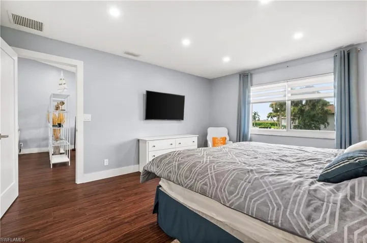 Bedroom with recessed lighting and dark wood finished floors
