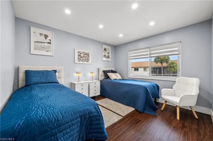 Bedroom with wood finished floors and recessed lighting