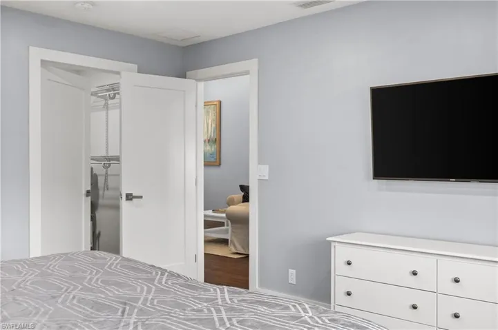 Bedroom with a walk in closet and baseboards