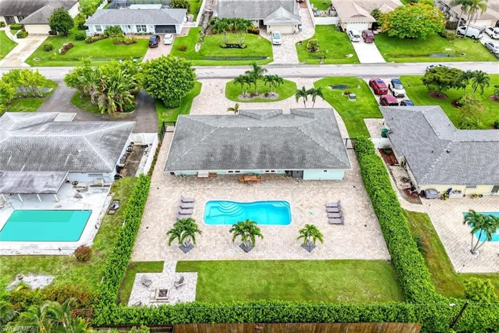 Drone / aerial rear view of large yard and pool