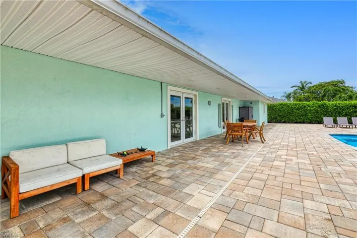 View of patio featuring french doors and a fenced in pool
