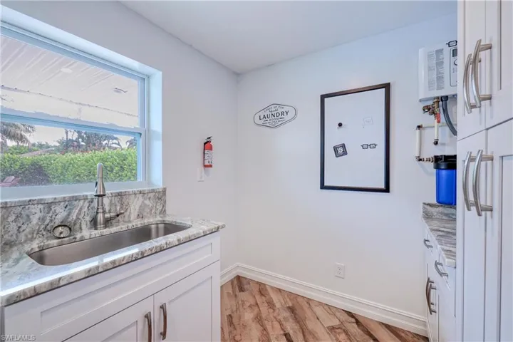 Laundry room with sink, counter space and lots of cabinets
