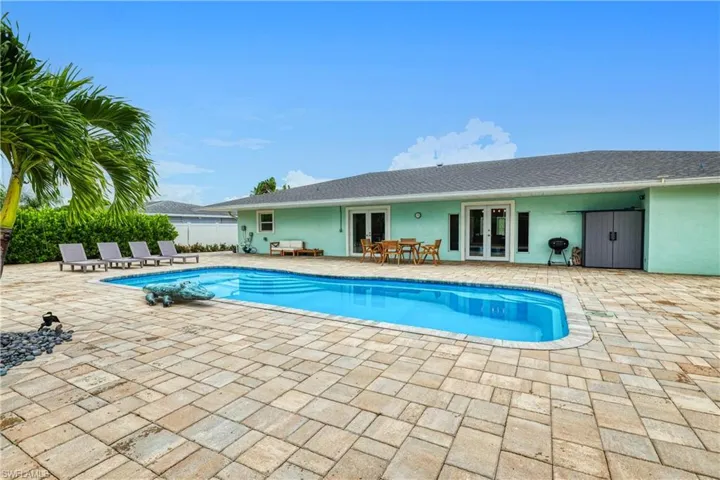 View of pool with a patio and french doors
