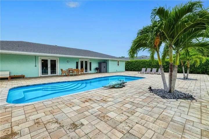 View of pool with a patio and french doors