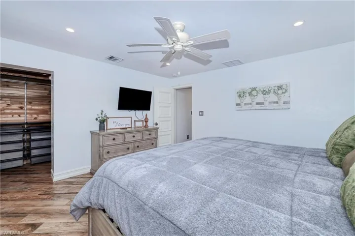 Master Bedroom featuring ceiling fan and wood plank tile flooring
