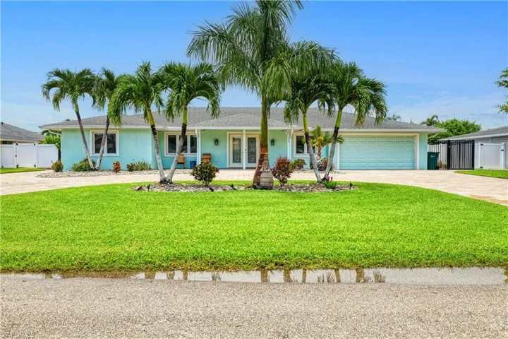 Ranch-style home featuring a garage and a front yard