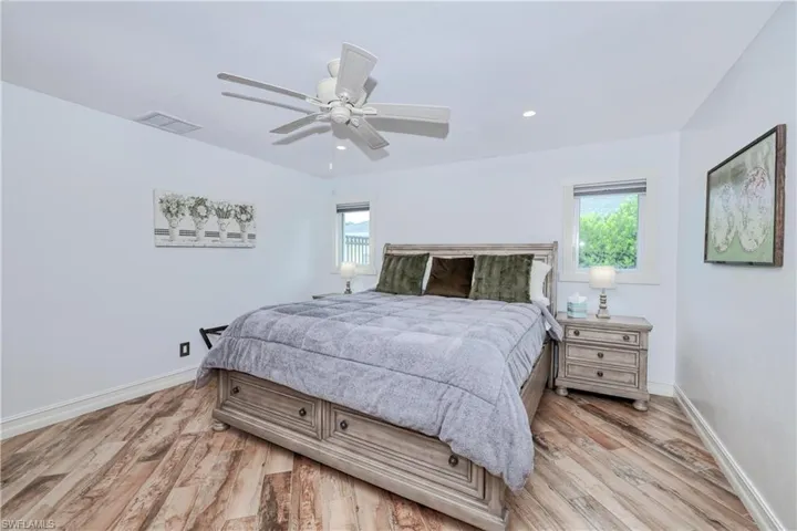 Master Bedroom with wood plank tile floors and ceiling fan