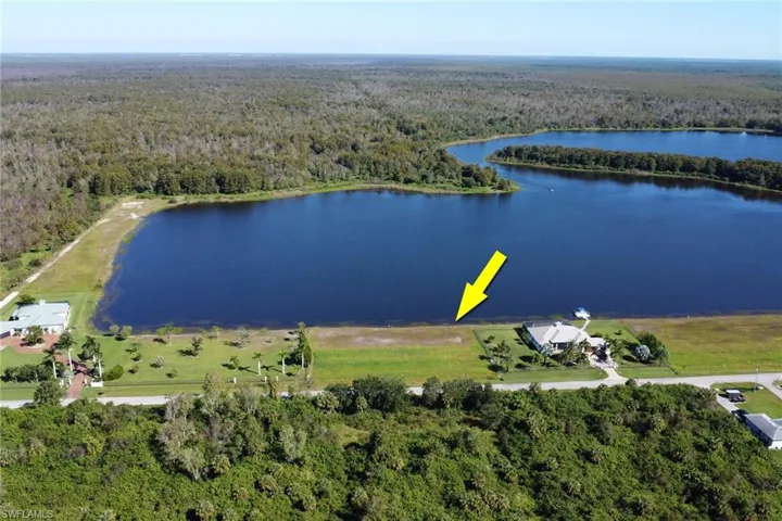 Aerial view of a heavily wooded area and a nearby body of water