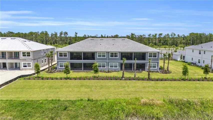 Rear view of property with a yard