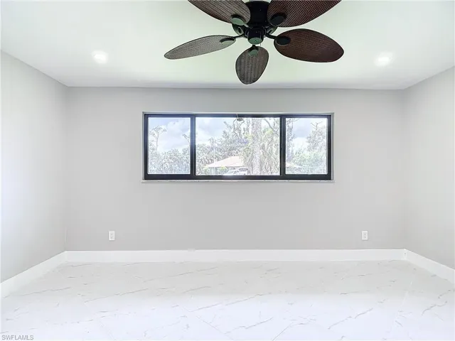 Empty room featuring ceiling fan