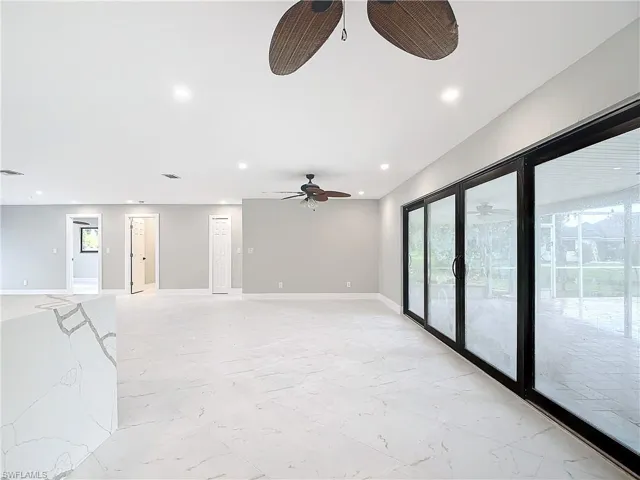 Tiled spare room with french doors and ceiling fan