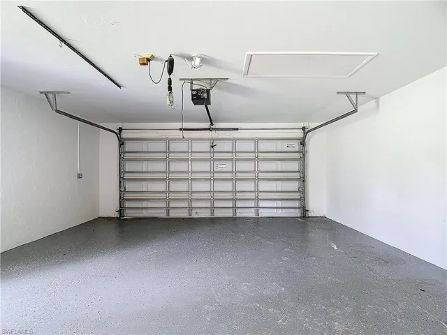Garage featuring a garage door opener