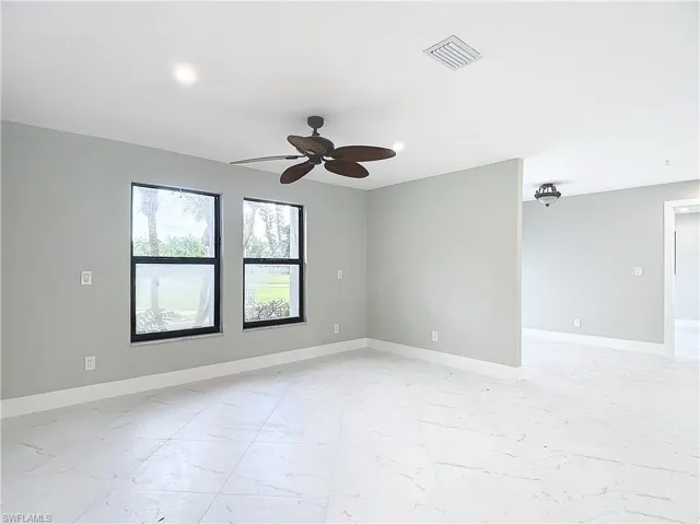 Tiled empty room with ceiling fan