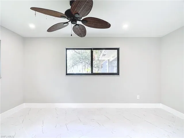 Unfurnished room featuring ceiling fan and light tile flooring