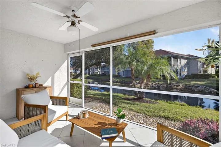 Sunroom featuring a water view