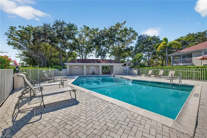 Community pool with a patio
