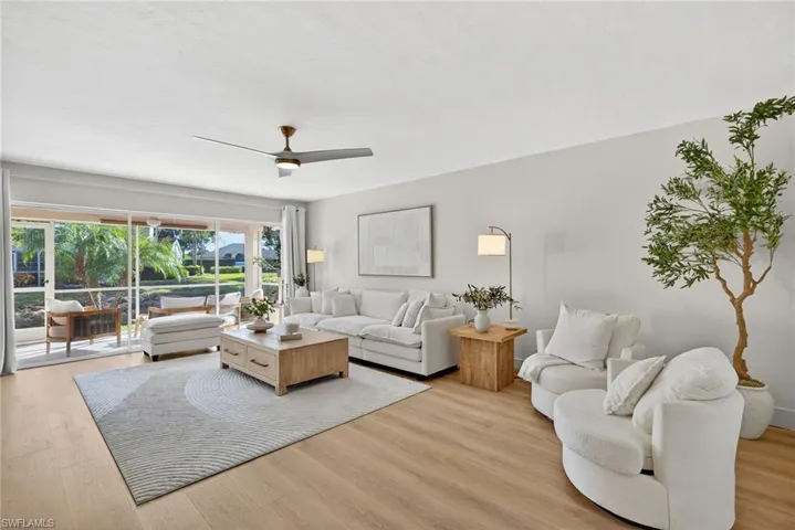 Living room featuring ceiling fan and light wood-style floors
