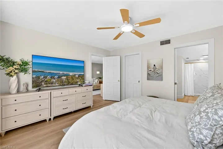 Bedroom with light wood-style flooring and a ceiling fan