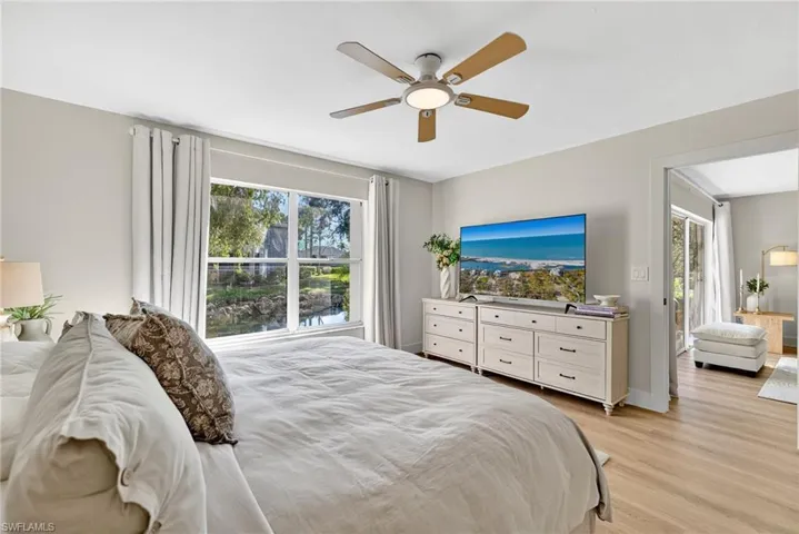 Bedroom with light wood finished floors and ceiling fan