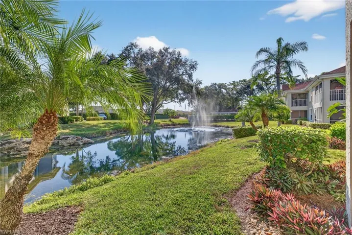 Surrounding community featuring a water view and a lawn