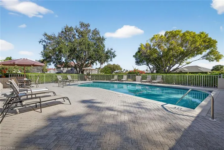 Community pool with a patio