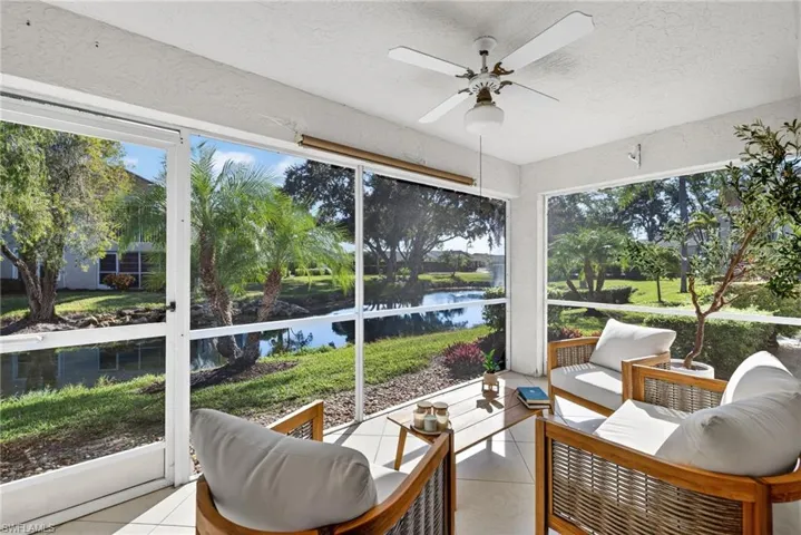 Sunroom with an outdoor hangout area, a ceiling fan, and a water view