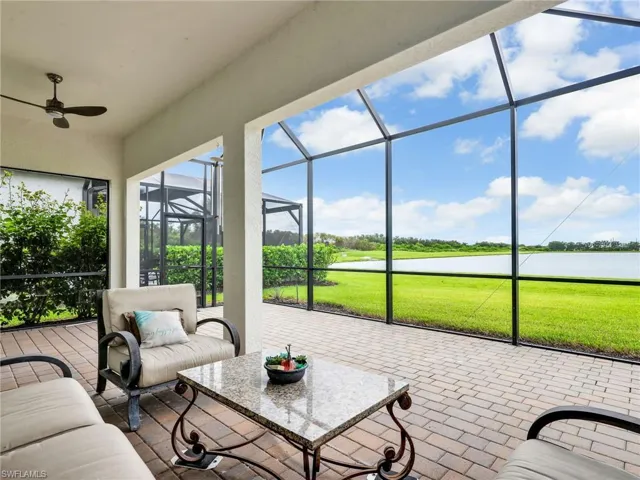 Sunroom / solarium featuring a water view, a patio, a ceiling fan, and an outdoor hangout area