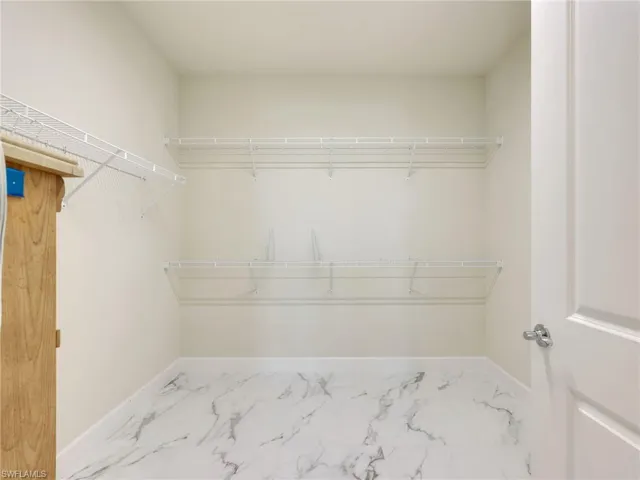 Walk in closet with marble look tiles