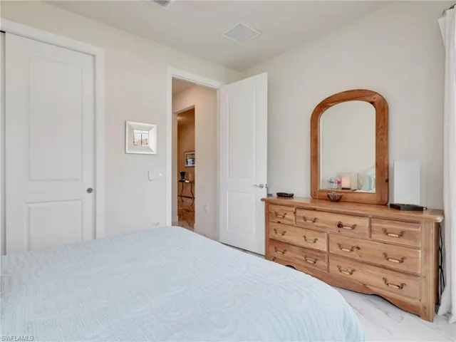 Bedroom with marble finish flooring