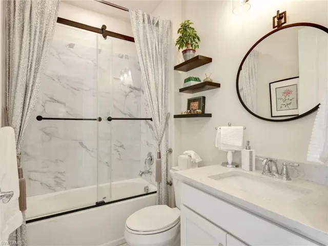 Bathroom with enclosed tub / shower combo and vanity