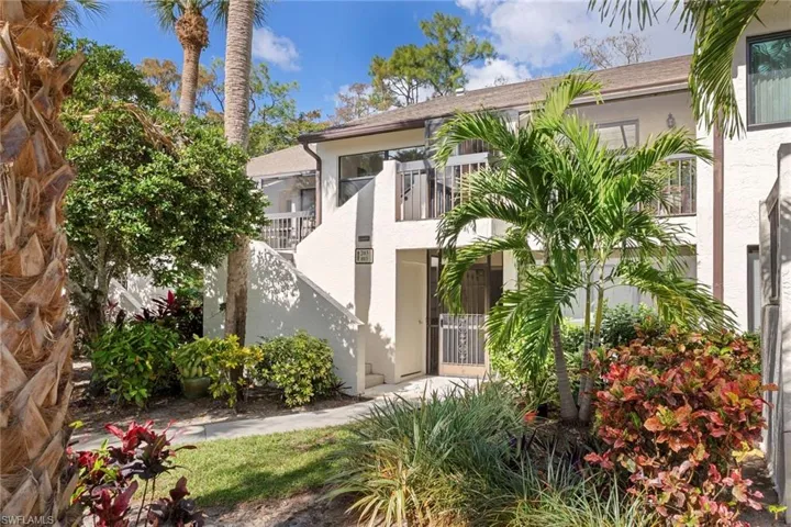 View of front of home featuring a balcony and stucco siding