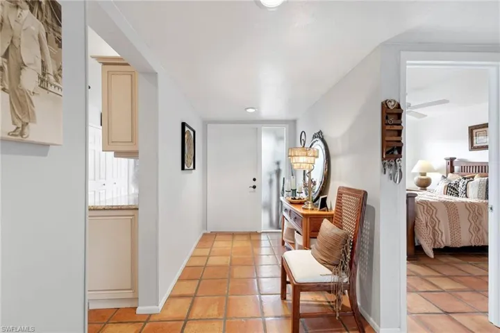 Hallway with light tile patterned floors and recessed lighting