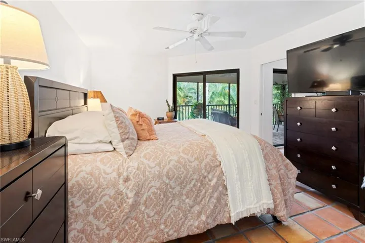 Bedroom featuring access to exterior and a ceiling fan