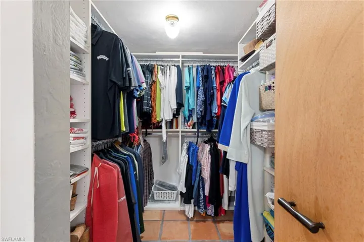 Walk in closet with light tile patterned flooring