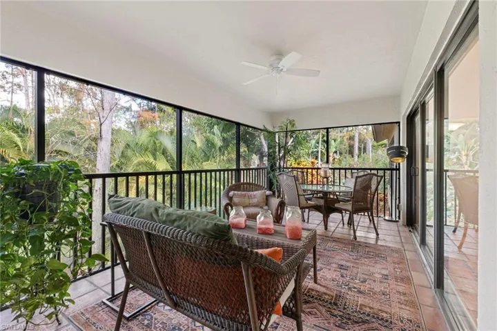 Sunroom featuring a ceiling fan, outdoor lounge area, and outdoor dining area