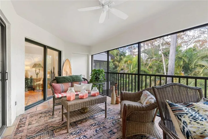 Sunroom / solarium featuring outdoor lounge area, a ceiling fan, and a balcony