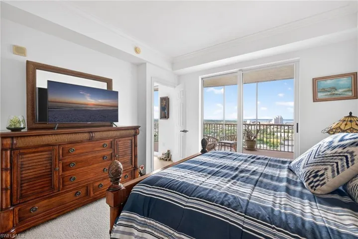 Bedroom with ornamental molding, access to outside, and carpet floors