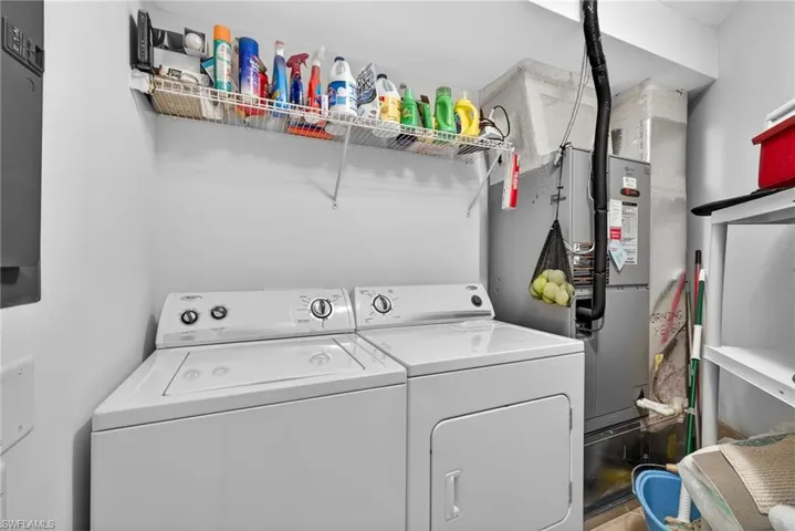 Laundry room featuring independent washer and dryer and heating unit