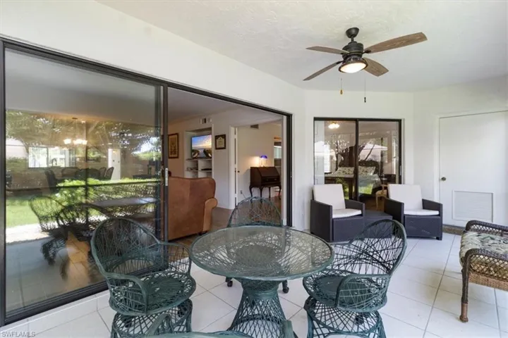 Dining area with ceiling fan, a wealth of natural light, and light tile patterned floors