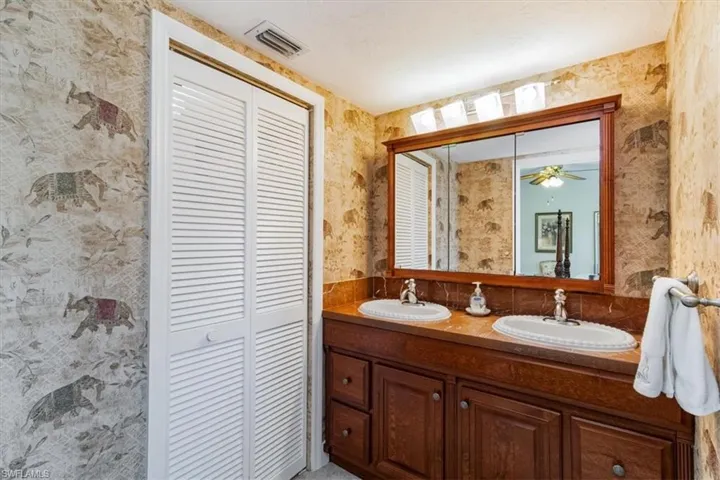 Bathroom with dual vanity and ceiling fan