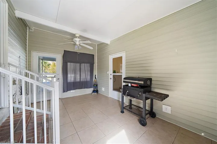 Sunroom featuring a ceiling fan and beam ceiling