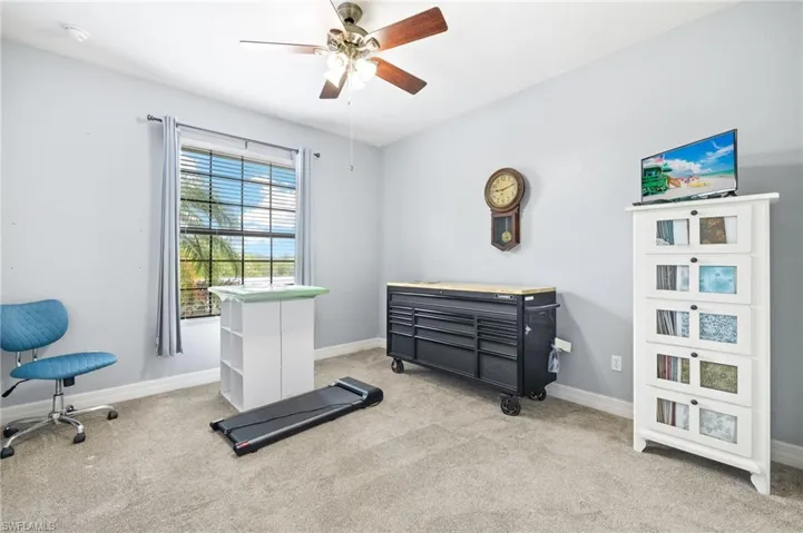 Bedroom featuring carpet floors, ceiling fan, and baseboards