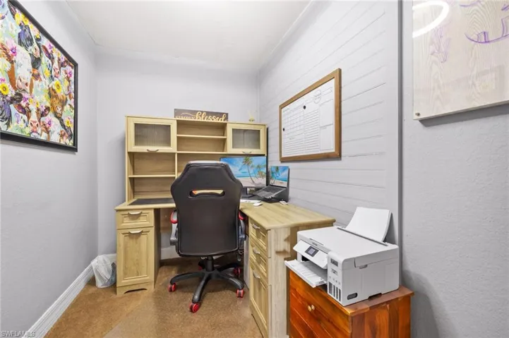 Super cute bonus room used as an office space upstairs with baseboards and carpet flooring